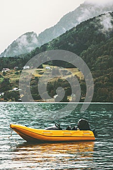 Yellow boat in sea fjord and Mountains Landscape