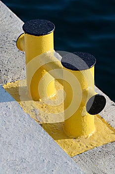Yellow bollard pier - device for yacht mooring in marina