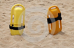 YELLOW BOOGIE BOARDS ON A SANDY BEACH