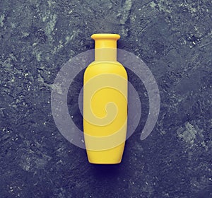 Yellow bottle of shampoo-gel for body and hair shower