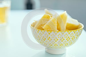 yellow bowl full of pineapple chunks photo
