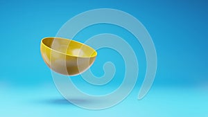 Yellow Bowl Spinning on Studio Blue Background