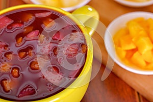 Yellow bowl with traditional tasty latin american colada morada berry juice, symbolizing blood from those deceased, day
