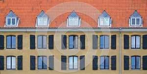 Yellow brick house with windows and shutters