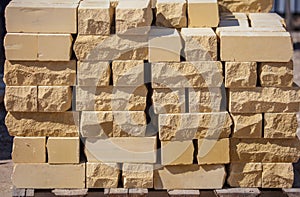 Yellow bricks on the construction site as a building material