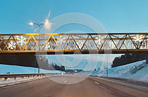 Yellow bridge through asphalt road