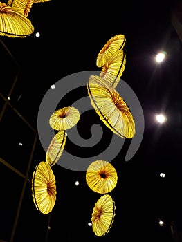 Yellow bright lampshades hanging from the ceiling