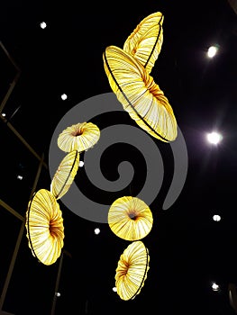 Yellow bright lampshades hanging from the ceiling