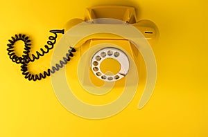 yellow bright retro telephone on a bright yellow background. for banners, advertisements, flyers, screensavers, covers