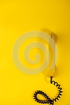 yellow bright retro telephone on a bright yellow background. for banners, advertisements, flyers, screensavers, covers