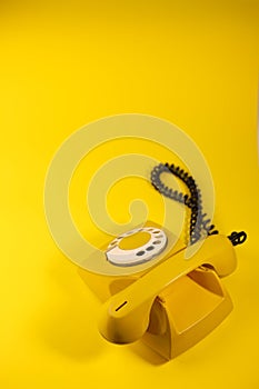yellow bright retro telephone on a bright yellow background. for banners, advertisements, flyers, screensavers, covers