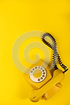 yellow bright retro telephone on a bright yellow background. for banners, advertisements, flyers, screensavers, covers