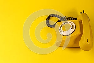 yellow bright retro telephone on a bright yellow background. for banners, advertisements, flyers, screensavers, covers