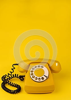 yellow bright retro telephone on a bright yellow background. for banners, advertisements, flyers, screensavers, covers