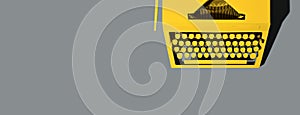 Yellow bright typewriter on gray background. Color of the year 2021