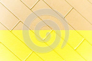 Yellow and brown brick wall texture. Two-color background