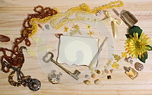 Yellow and Brown Jewelry and Decorations with Vintage Key and Blank Paper With Burned Edges