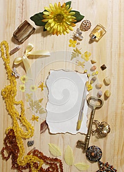 Yellow and Brown Jewelry and Decorations with Vintage Key and Blank Paper With Burned Edges
