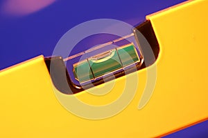 Yellow bubble level in balance