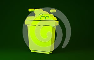 Yellow Bucket with soap suds icon isolated on green background. Bowl with water. Washing clothes, cleaning equipment