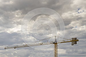 yellow building construction crane with counterweights