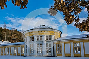 Yellow building of Ferdinand colonnade with mineral water at spa town Marienbad