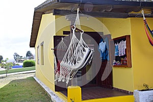 yellow building with hammock, neighborhood near the equator line in a park near Quito