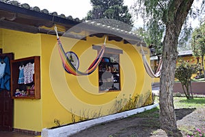 yellow building with hammock, neighborhood near the equator line in a park near Quito