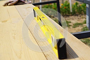 Yellow building level . working tool on wooden background