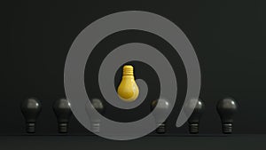 Yellow bulb inverted and higher among black bulbs on dark background. Leadership, authority, great idea concepts.