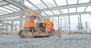 Yellow bulldozer at the construction site. Bulldozer at the construction site. Heavy construction equipment