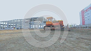 Yellow bulldozer at the construction site. Bulldozer at the construction site. Heavy construction equipment