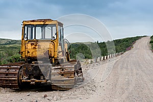 Yellow bulldozer, on a dirt road