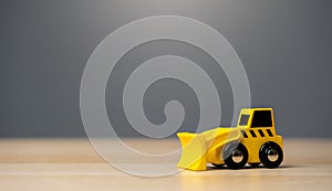 The yellow bulldozer toy. Construction works. Clearing and leveling the land. Building destruction. Take down Illegal construction