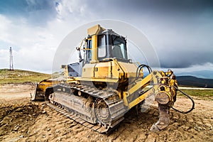 Yellow bulldozer on tracks