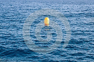Yellow buoy on background of blue sea, concept loneliness