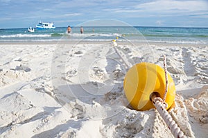 Yellow buoy on the beach for making swimming safety area for tourists