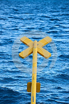 Yellow buoy on the sea waves background