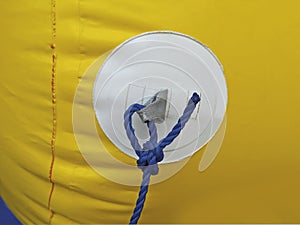 Yellow buoy texture with blue rope and nautical knot called