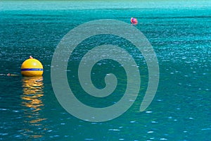 Yellow buoy on turquoise sea