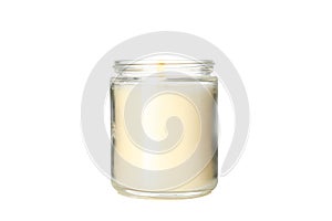 Yellow burning candle in glass jar isolated on background