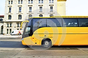 Yellow bus for tourists transporation in Prague ci