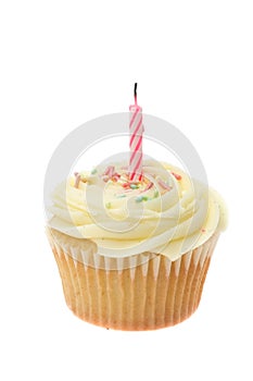Yellow buttercream iced cupcake with a single birthday candle