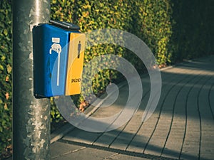 Yellow button for disabled pedestrians with the inscription PRESS on a pedestrian crossing. Selective focus