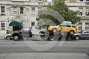 Yellow cab on a tow truck New York USA
