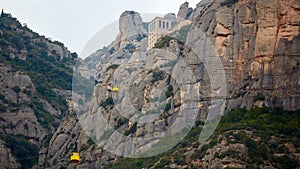 Yellow cable car in the Aeri de Montserrat rise to de Montserrat Abbey near Barcelona, Spain, Catalonia.