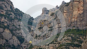 Yellow cable car in the Aeri de Montserrat rise to de Montserrat Abbey near Barcelona, Spain, Catalonia.