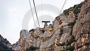 Yellow cable car in the Aeri de Montserrat rise to de Montserrat Abbey near Barcelona, Spain, Catalonia.