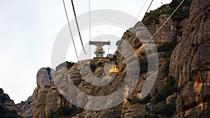 Yellow cable car in the Aeri de Montserrat rise to de Montserrat Abbey near Barcelona, Spain, Catalonia.