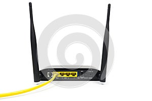 Yellow Cable connected to a wireless router modem isolated on white background